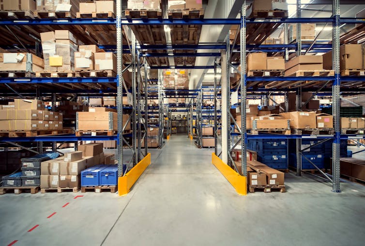 logistics warehouse with shelves complete with packages of various sizes.