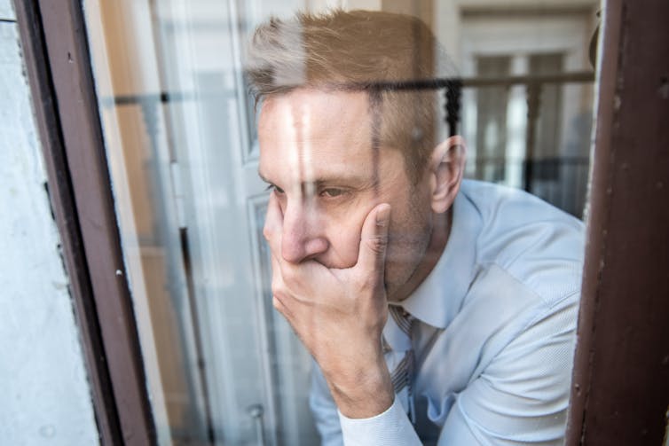 A man looking out of a window