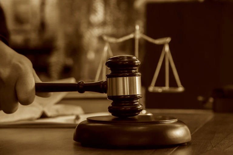 A hand puts a gavel down