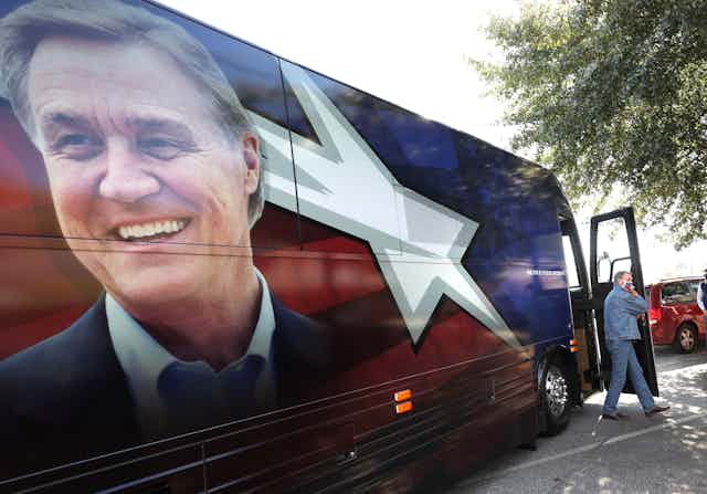 Senator David Perdue walks off of his campaign bus.