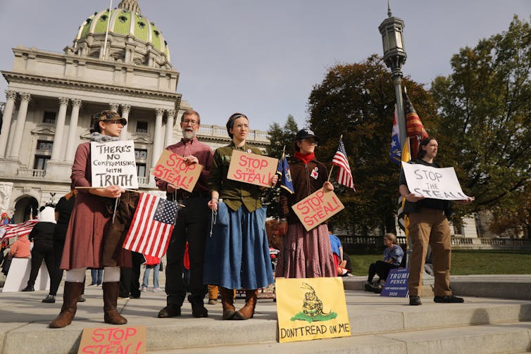 A post-election protest display includes the Gadsden flag