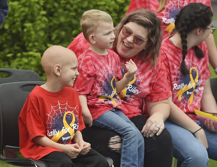 A little boy with cancer at a drive-by birthday party for him.