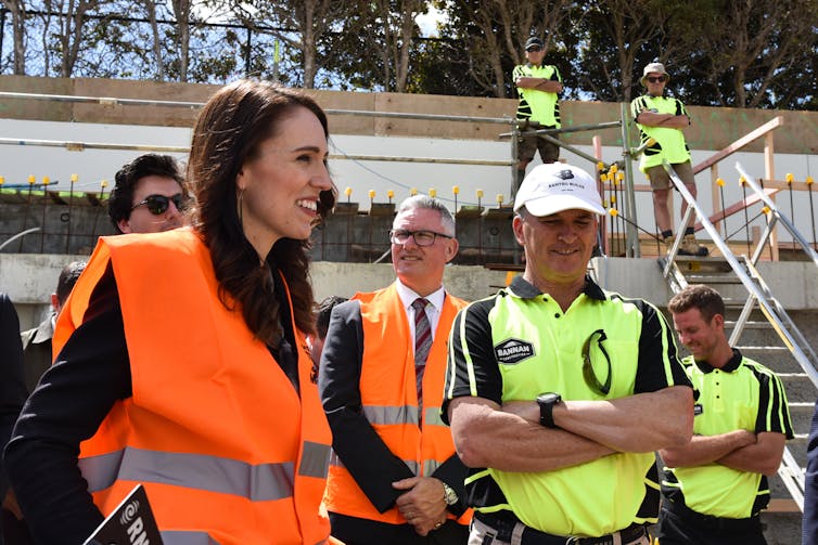 Jacinda Ardern with builders on a site