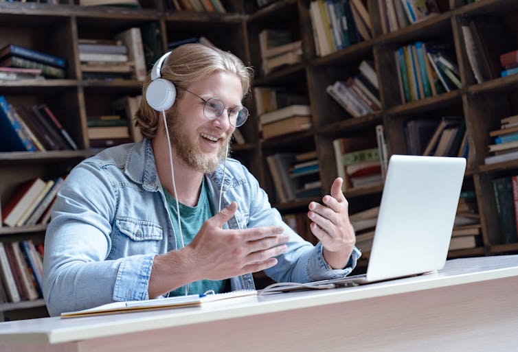 Student talking as he studies online