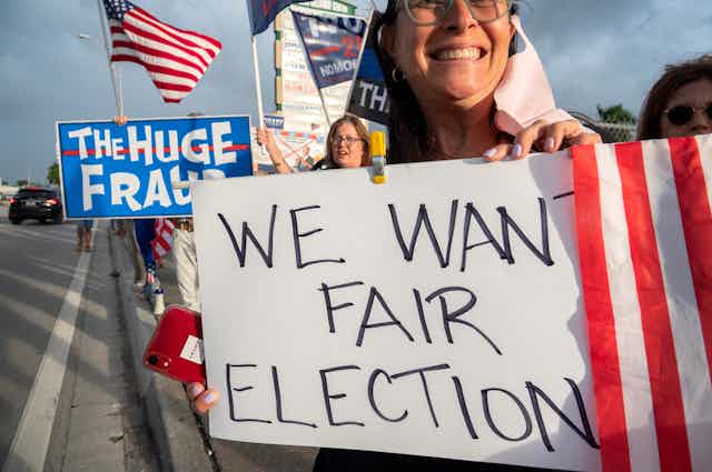 A US protestor holds a sign reading "We want fair election"