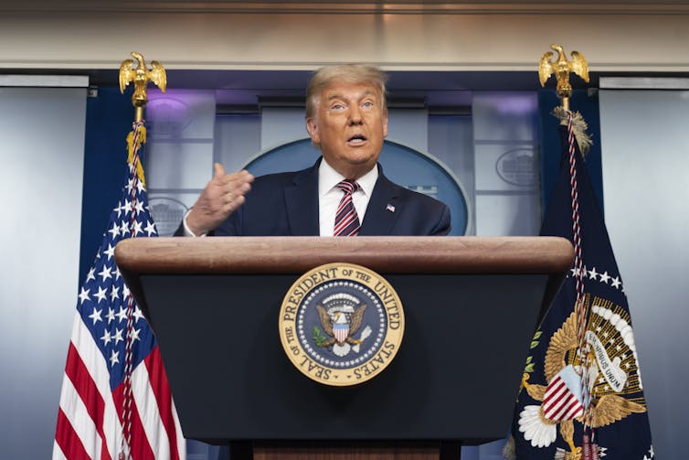 Donald Trump in front of a lectern at the White House.