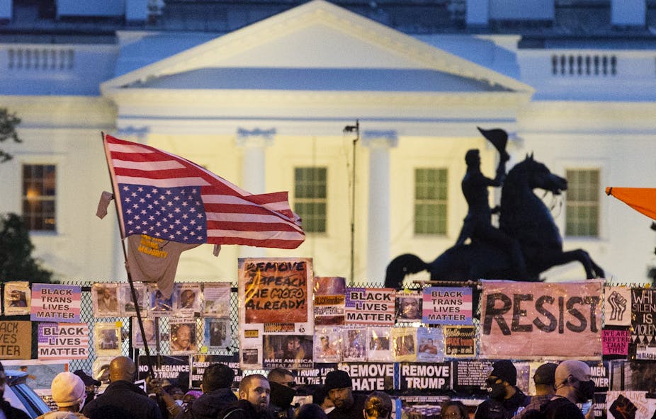 An upside down US flag waved by protesters outside the White House. 