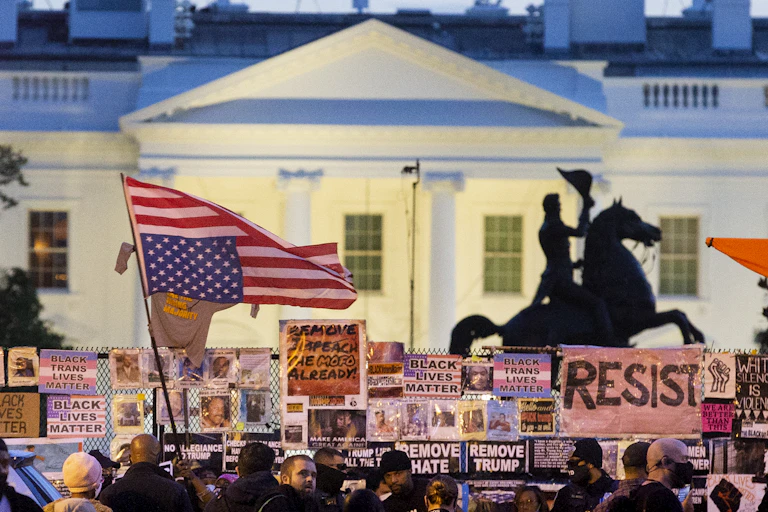 An upside down US flag waved by protesters outside the White House.