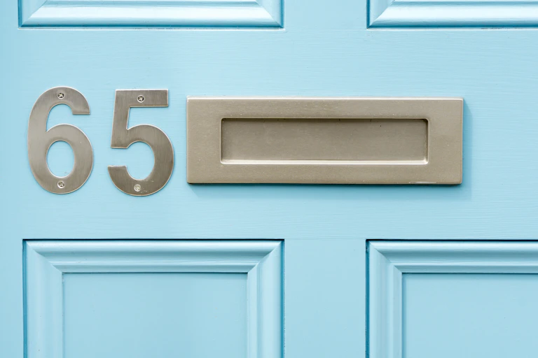 Blue door with a house number on it.