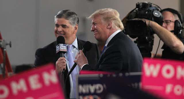 Sean Hannity of Fox Nes interviews Donald Trump at a rally in 2018