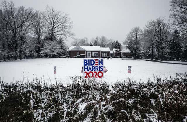 A sign for Biden and Harris in a snowy field. 