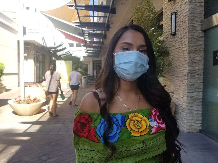 Young woman in Phoenix wearing mask.