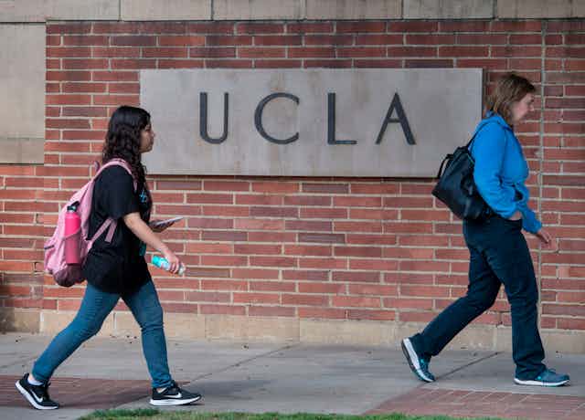 Two female students walk on the campus of UCLA.