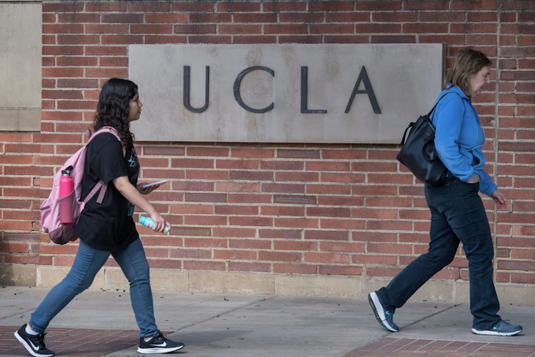 Two female students walk on the campus of UCLA.