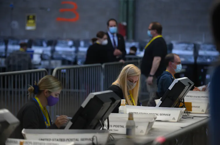 Election officials count ballots.
