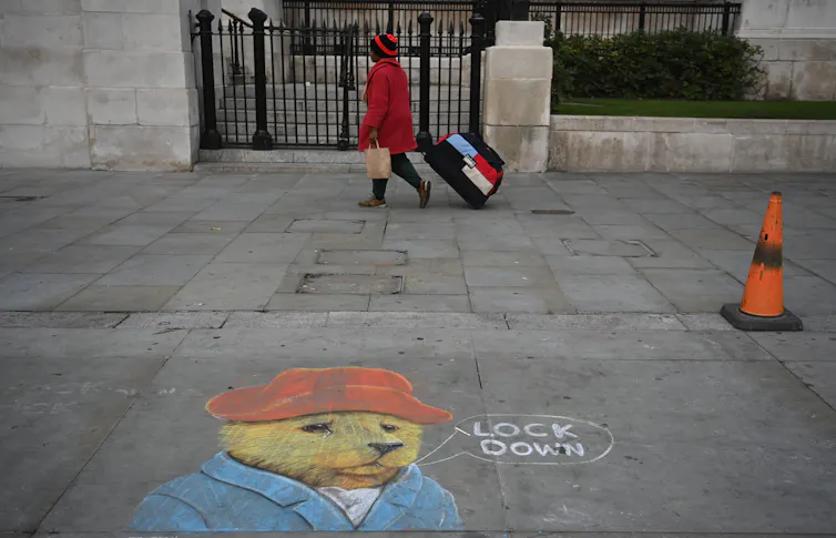 A chalk drawing on a London street of Paddington Bear say 'lock down'.