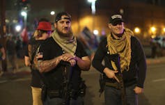 Two armed Trump supporters.