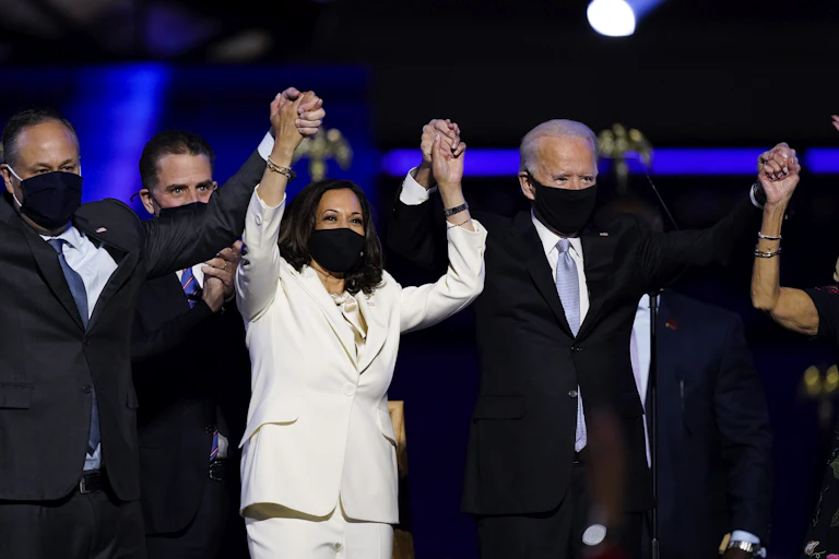 President-elect Joe Biden, his wife Jill Biden, and members of the Biden family, along with Vice President-elect Kamala Harris, her husband Doug Emhoff stand on stage Saturday, Nov. 7, 2020, in Wilmington, Del.