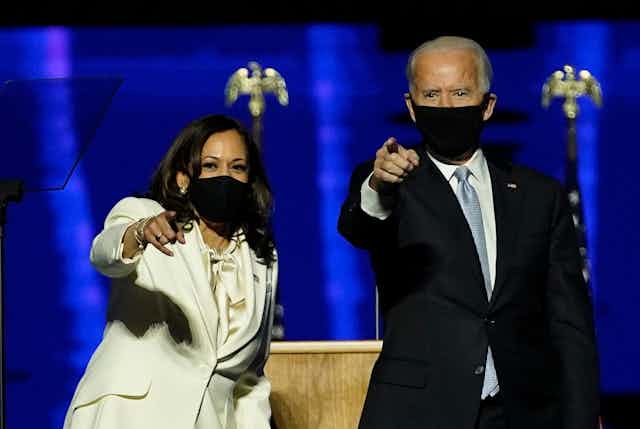 Kamala Harris and Joe Biden point to their crowd of supporters after giving their victory speeches.