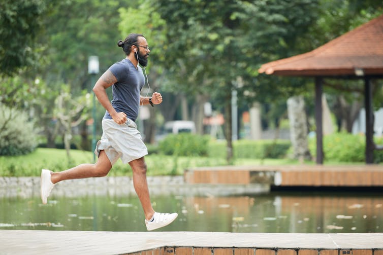 A man runs in a park.