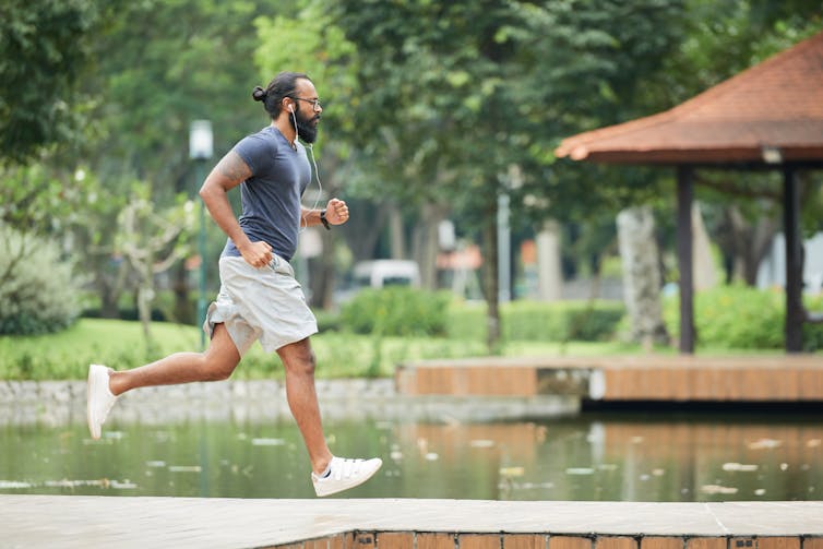 A man runs in a park.