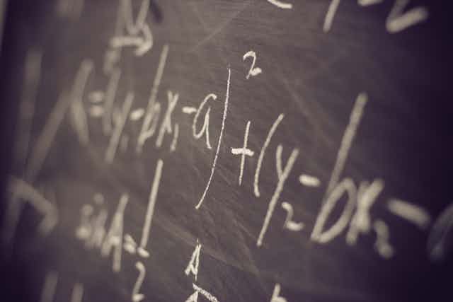 Maths equations on a blackboard.