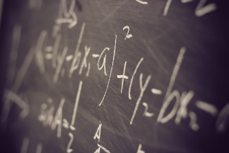 Maths equations on a blackboard.