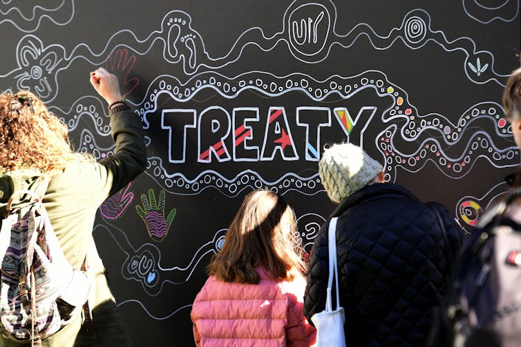 The word 'treaty' appears on a wall.