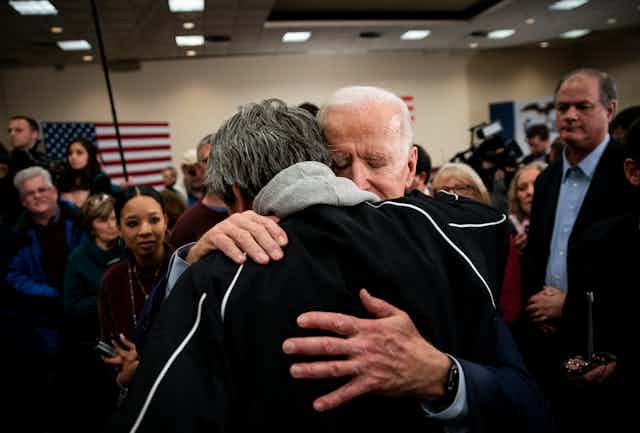Joe Biden hugging a man during a campaign event.