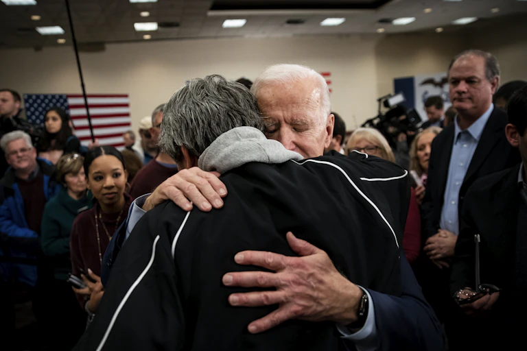 Joe Biden hugging a man during a campaign event.