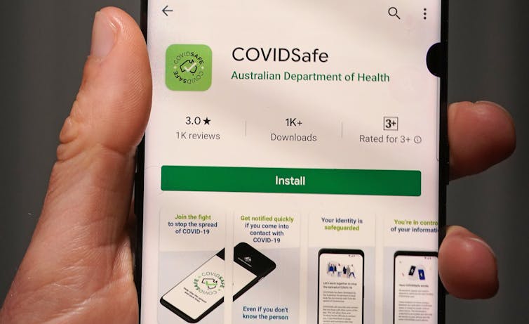 A person looks at the COVIDSafe app on their phone.