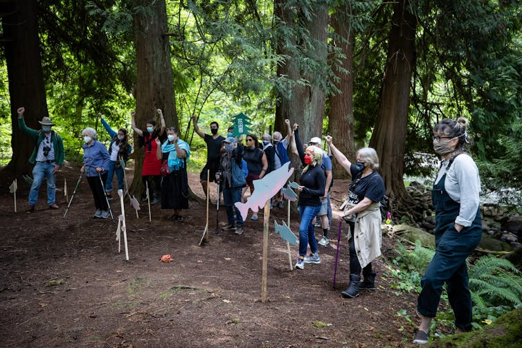 People walk through a forest.