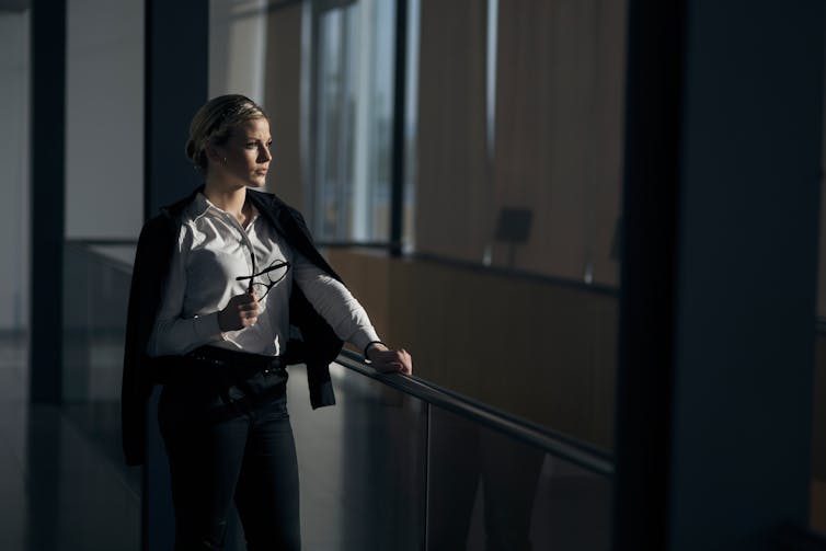 Young businesswoman looking out window.