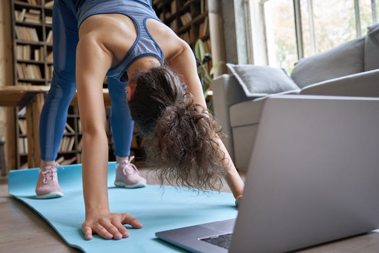 Teenage girl doing yoga following exercise video