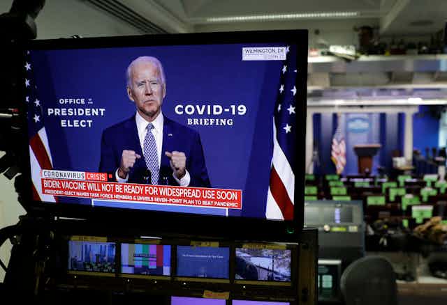 A tv screen in a US newsroom showing president-elect Joe Biden .