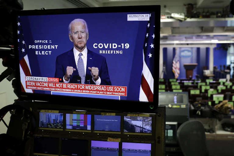 A tv screen in a US newsroom showing president-elect Joe Biden .