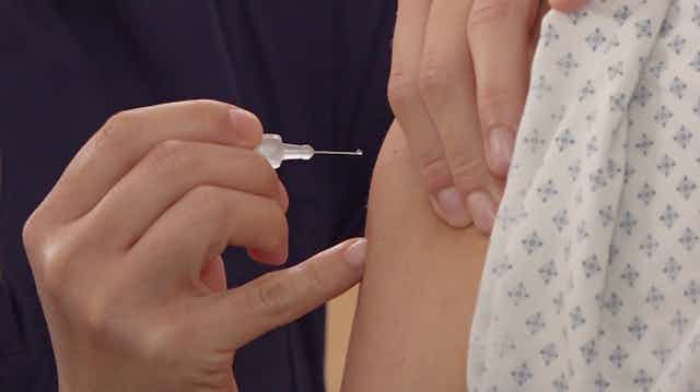 Person receiving a COVID vaccine in Mexico.