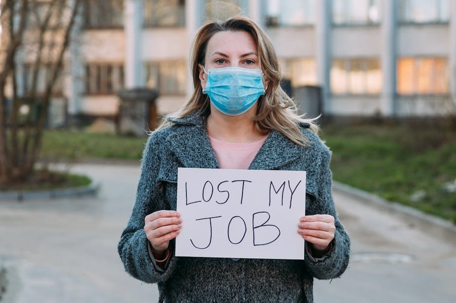 Woman holding sign saying lost my job
