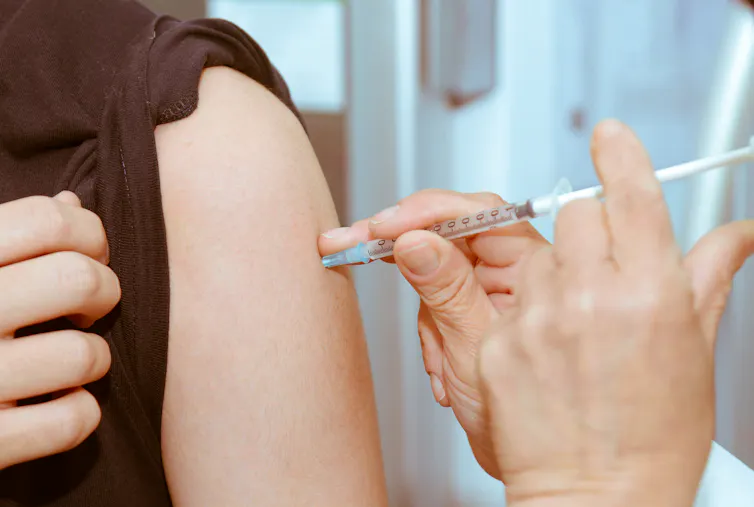 A man receiving an injection in his arm.
