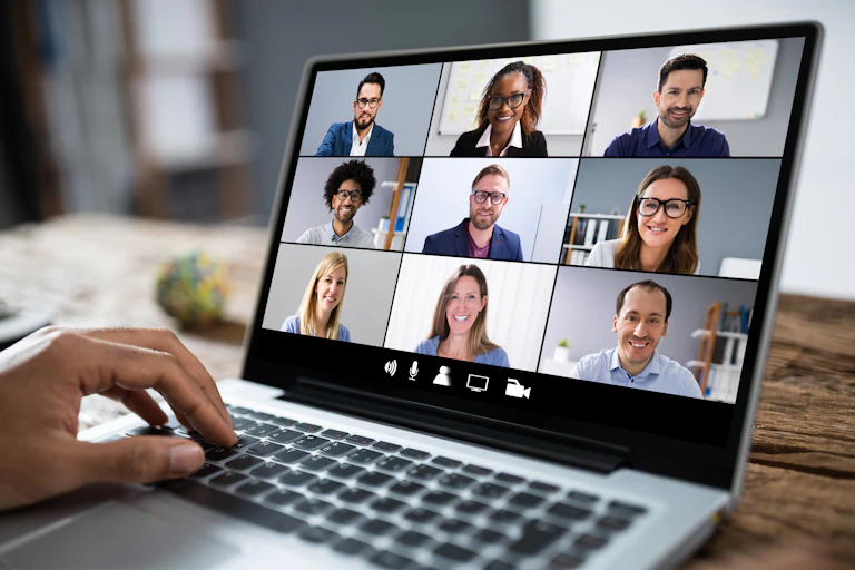 Faces of people on a laptop screen as they have a teleconference