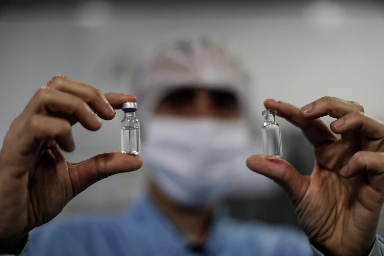 Medic holding two vaccine vials
