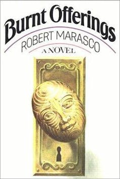 Front cover of Burnt Offerings featuring a door knob with a face on it partially turned.