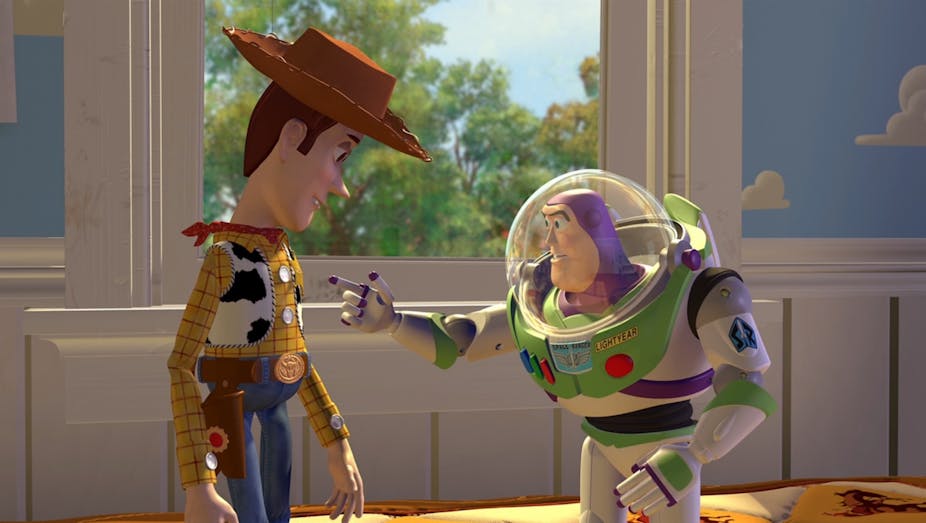 Plastic space toy Buzz Lightyear points at cowboy toy Woody.