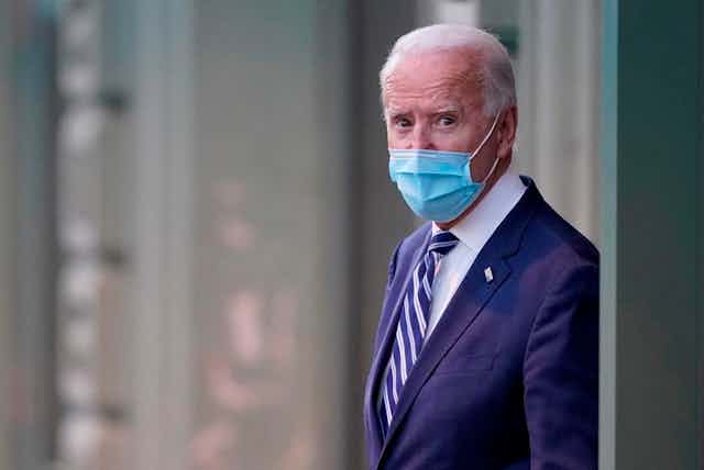US president-elect Joe Biden wearing mask coming out of building