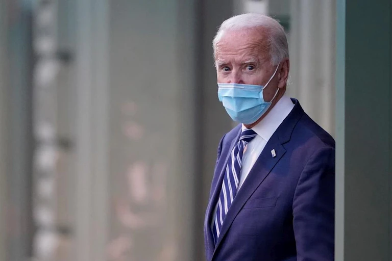 US president-elect Joe Biden wearing mask coming out of building
