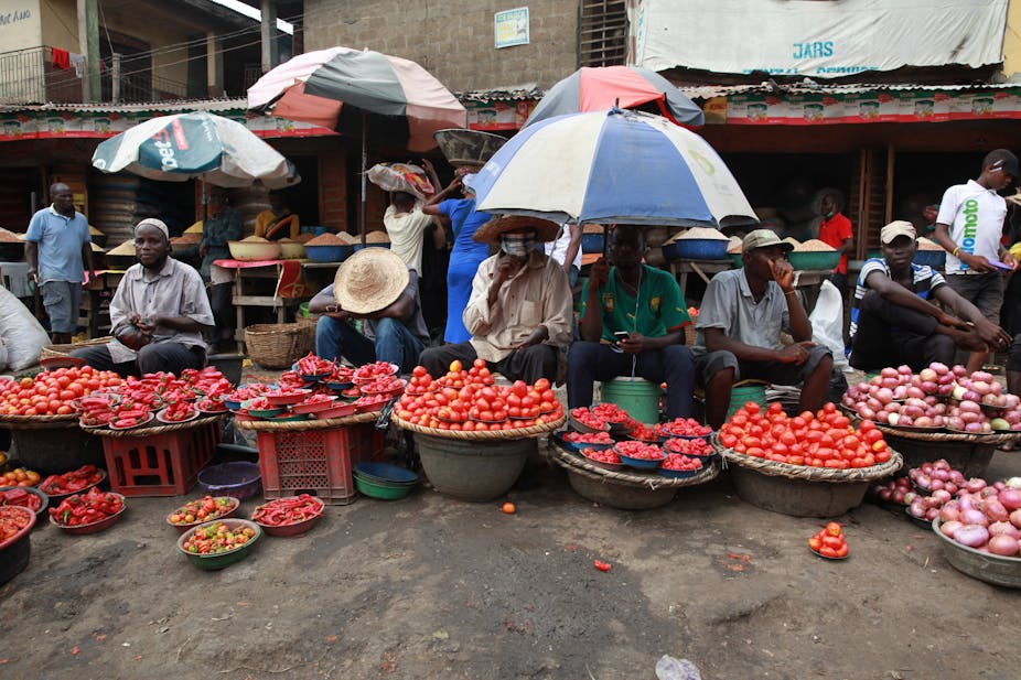 A row of vendors display farm produce for sale in a food market in Lagos, Nigeria's commercial capital.