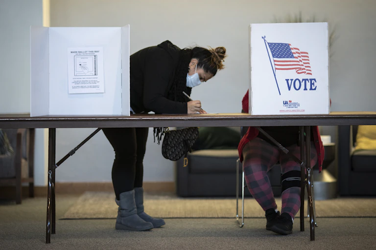 masked woman voting