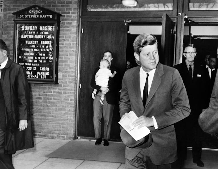 US President John Fitzgerald Kennedy leaves the Saint Stephen Martyr catholic church after attending mass, on October 28, 1962 in Washington DC.