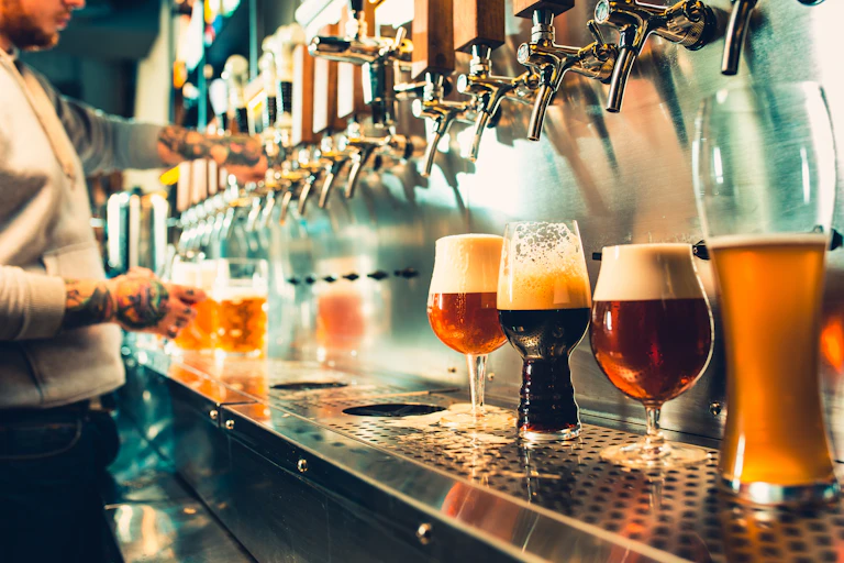A bartender serving a variety of beers