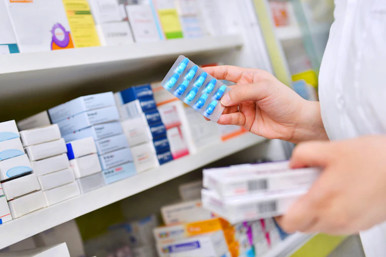A pharmacist holding medicine